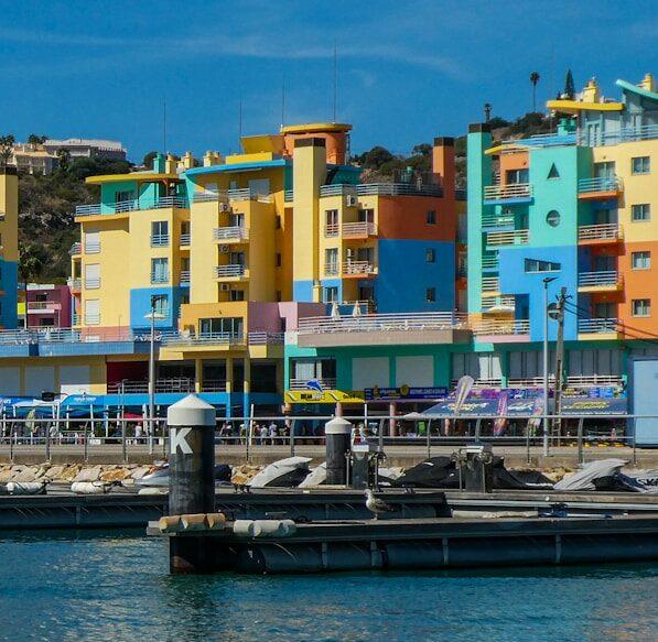 a boat docked in a harbor next to colorful buildings